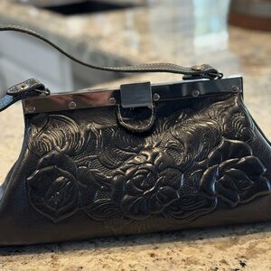 Unique woman’s handbag in detailed genuine leather.